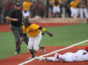 Freshman Cornell Nixon (5) scores from third after a throwing error from Louisville in Game 1 of the Super Regionals at Patterson Stadium. 