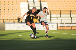 Marit Sandtroeen fights off a defender. Photo by Matt Boggs|The Sentinel