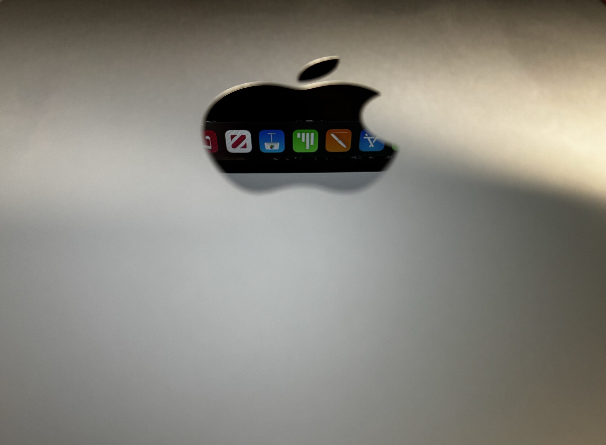 In-focus app icons within a Mac Mini reflective logo.