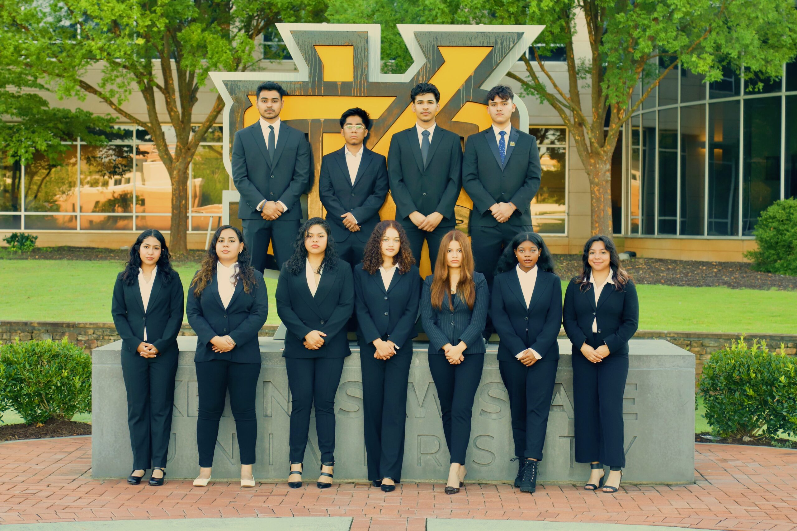 ALPFA members gathered in front of the KSU sign.