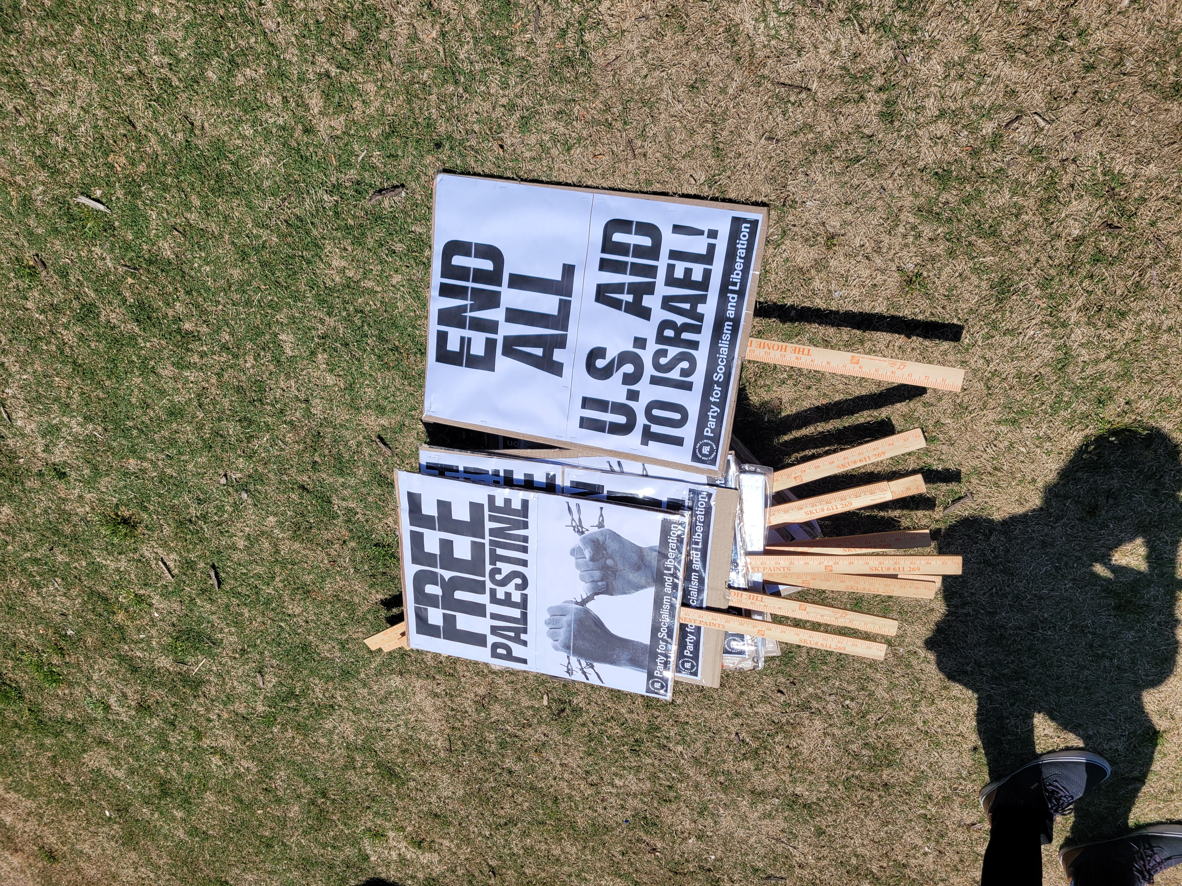 Picket signs at the April 15 protest. Photo Credit: Erin Cater