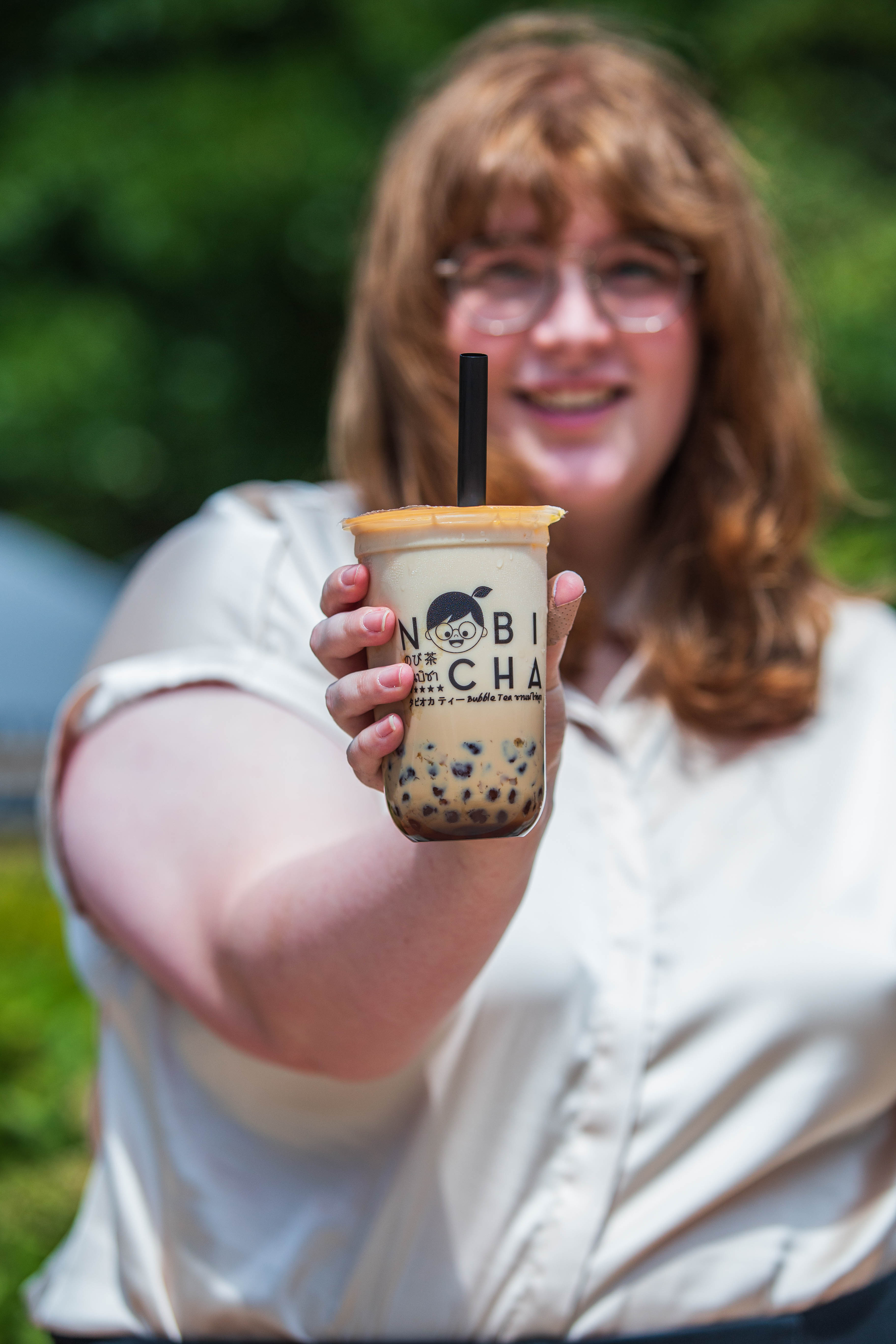 A Nobi Cha drink being held up.