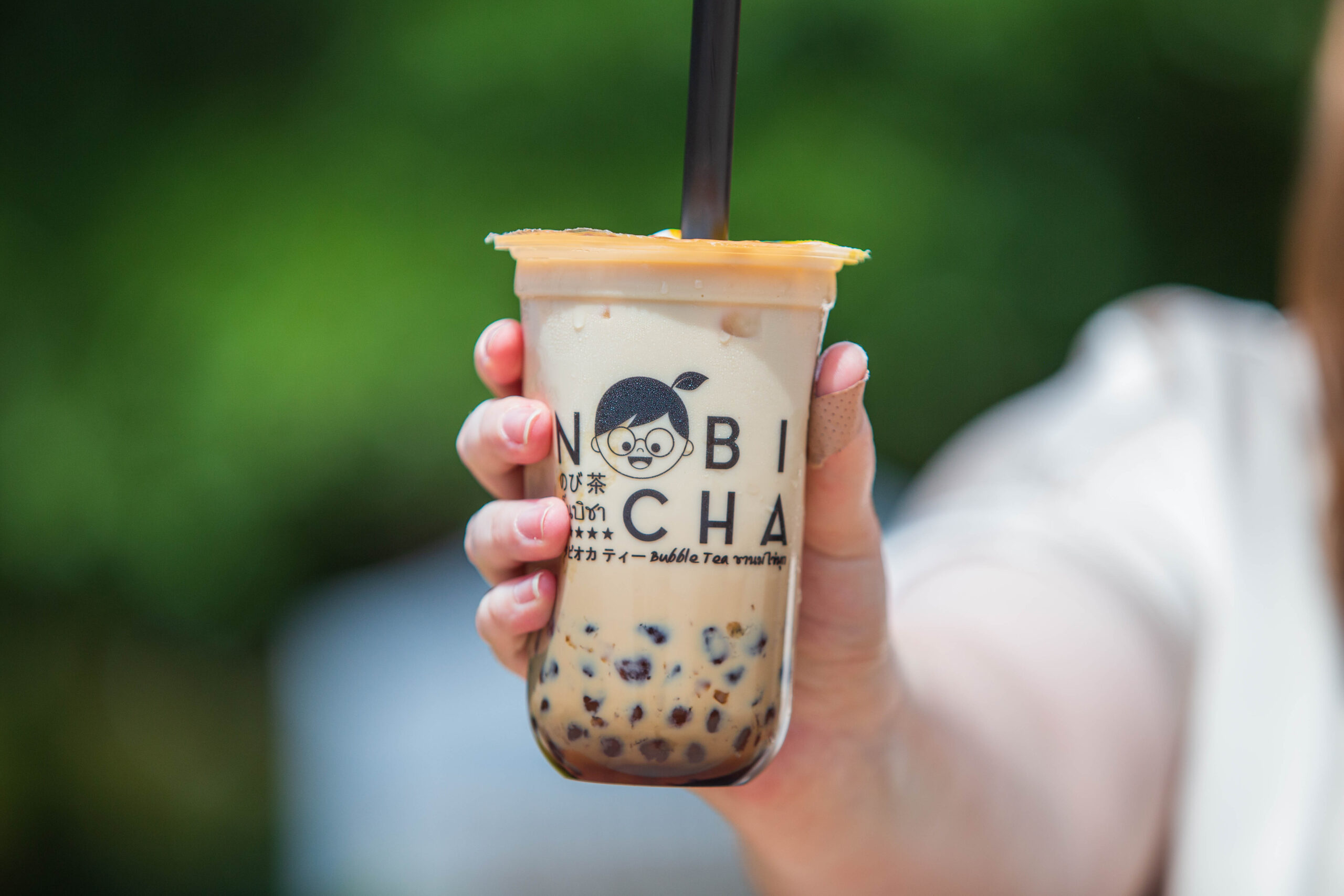 A Nobi Cha drink being held up.