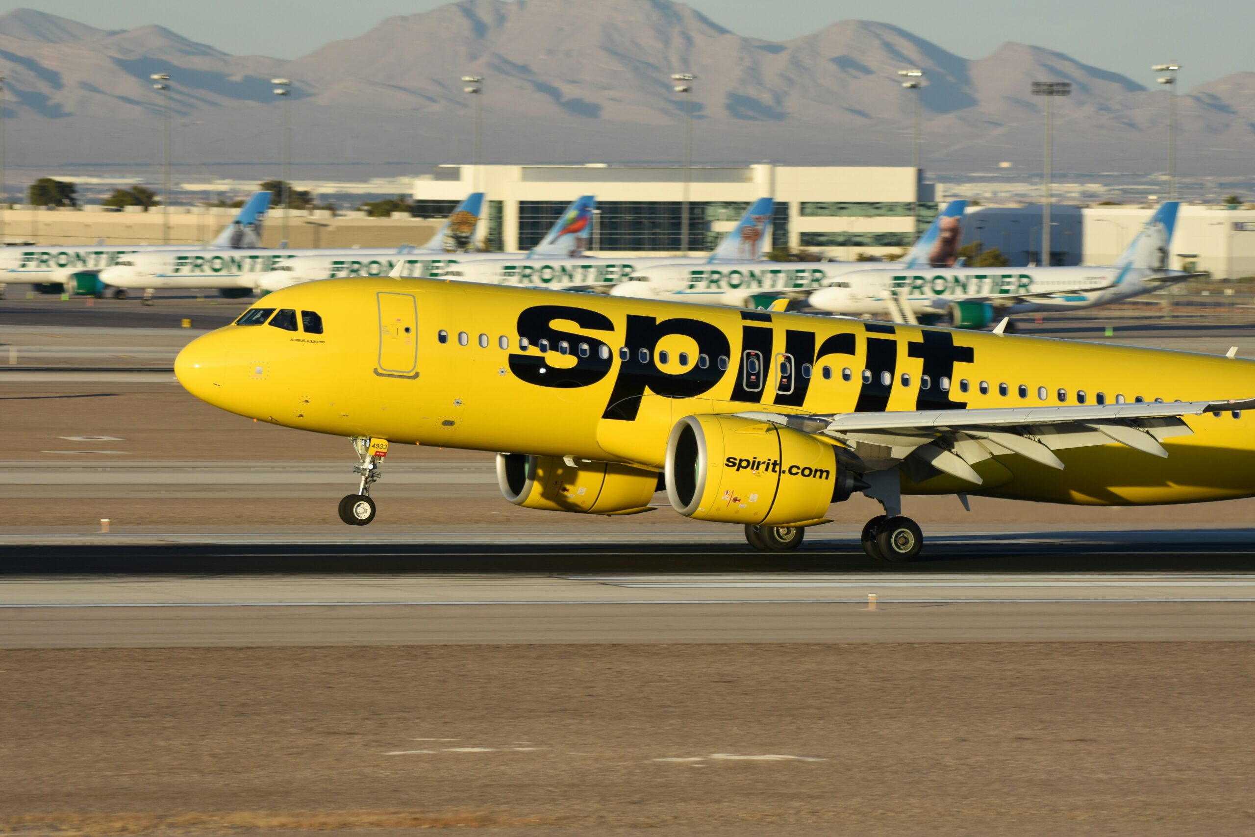 Yellow spirit plane taking off with other planes in background